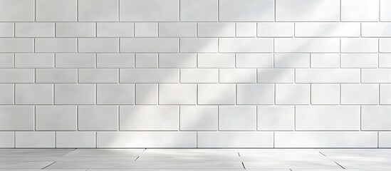 White tile wall with sunlight shadows.