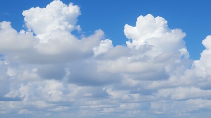Fototapeta premium A breathtaking view of fluffy cumulus clouds against a vibrant blue sky, creating a picturesque summer day scene.