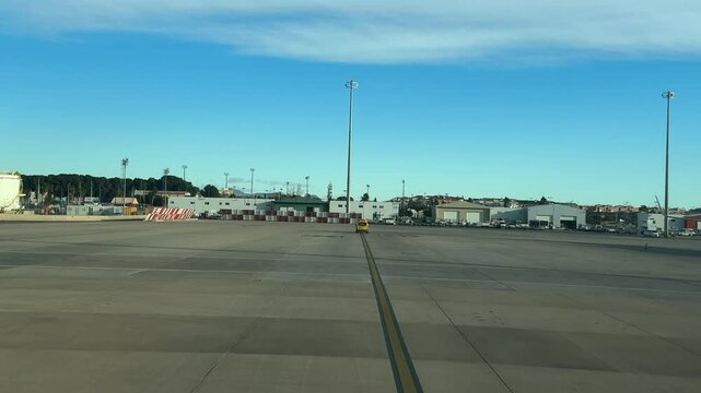 A pilot&rsquo;s perspective from an airplane cockpit floowing the follow-me yellow car after landing, with a blue sky at the blue hour.