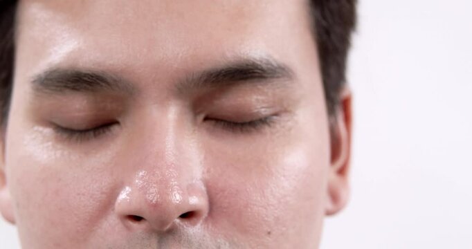 Panning from the left to the right, revealing a close-up shot of a male model's face.