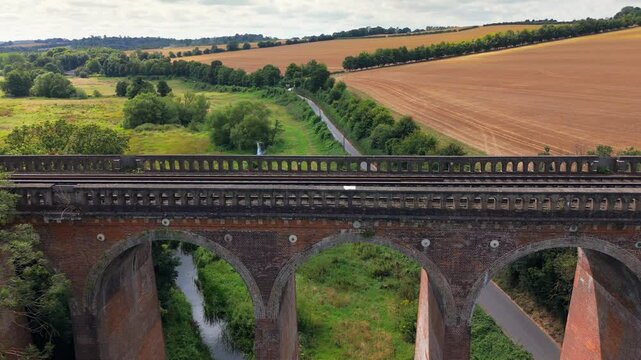 Aerial close-up panning view, famous bridge arches, pillars, train track