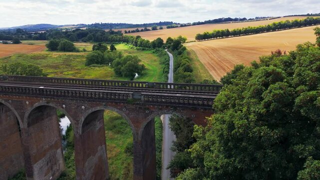 Aerial dolly reveal, arched bridge structure, countryside scenery