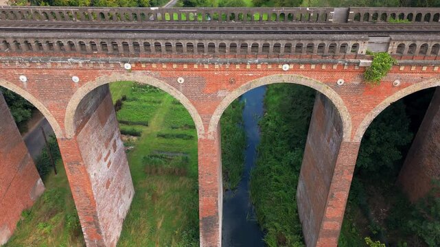 Aerial slow descend close-up view, spanning arches, bridge construction