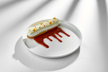 A classic eclair dessert, filled with creamy custard and topped with a drizzle of rich caramel...