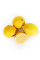 A whole lemon and a halved lemon placed on a white background