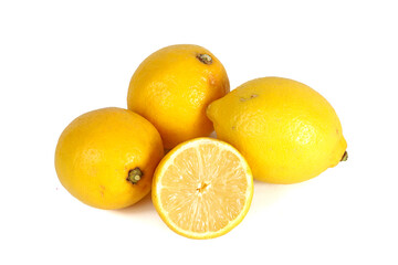 A whole lemon and a halved lemon placed on a white background
