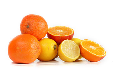 A fresh assortment of oranges and lemons isolated on a white background