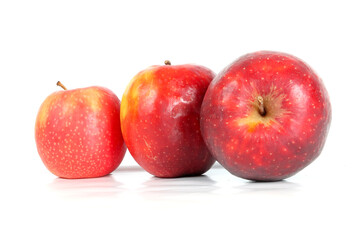 three apples placed on a clean white background. The apples are fresh, with smooth, shiny skin