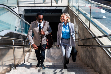 Mauture black businessman and middle aged businesswoman travelling for work