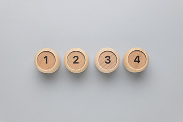 One, two, three, and four number on round wood blocks, step-by-step process, instructions, and...