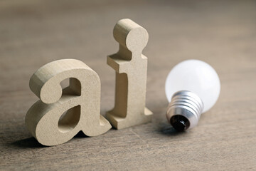 AI (Artificial Intelligence), wooden alphabet with a light bulb, knowledge about AI, tips and tricks
