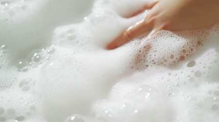 Obraz premium Relaxing bath experience with gentle hand in soothing foam bubbles