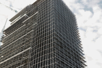 Metal Scaffolding on Building Facade, high-rise construction, industrial design, urban development