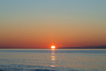 Fototapeta premium Sunset at sea, colorful skyline and ocean breeze, summer vacation and tropical paradise.