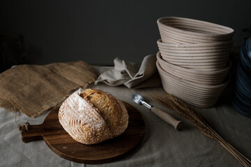 Artisan Batard Sourdough healthy Bread. Open crumb high hydration Sourdough french country bread set on dark background.