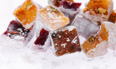 Sweet food Turkish delight, assorted rahat locum in form of cubes with nuts and powdered sugar, traditional food, on white background