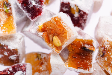 Sweet food Turkish delight, assorted rahat locum in form of cubes with nuts and powdered sugar, traditional food, on white background