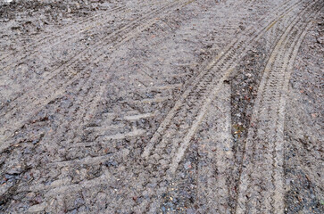 Tire tracks on mud, muddy road and ground
