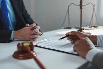 Two lawyers engaged in a detailed discussion about a contract, with a gavel and scales of justice...