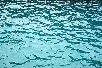 Texture of azure calm rippling Mediterranean Sea water. Sea waves background. Nature backdrop