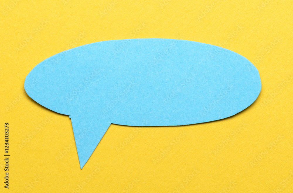 Aufkleber blue cut out blank paper speech bubble of round shape with copy space for text on yellow background,