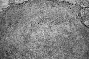 gray background, photo shows texture of old plaster on the wall of a building