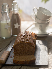 Cholocate sponge cake snack in a rustic atmosphere accompanied by a chocolate and milk drink