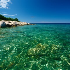 Fototapeta premium Clear Turquoise Sea With Rocks And Sunny Sky