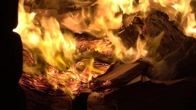 The burning of joss paper within an incense burner at a traditional Taiwanese temple.