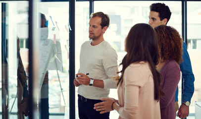 Office, meeting and glass wall for collaboration, training and planning with discussion for erp report. Men, women and team for business, strategy or sticky notes for partnership or b2b project