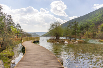 A view of a walkway over the lake in Blue Moon Valley in Lijiang, China