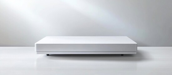 White platform sits on studio floor, light beams on wall, product display