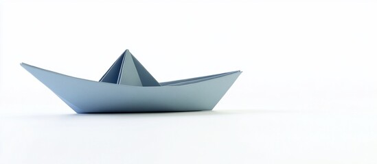 Naklejka premium Blue paper boat on white background, simple origami, blank space
