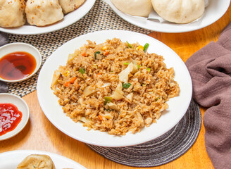 Egg Fried Rice with Steamed Buns and Dipping Sauce served in plate isolated napkin side view of chinese dim sum food