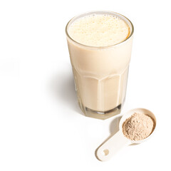 Glass with protein shake and powder in scoop