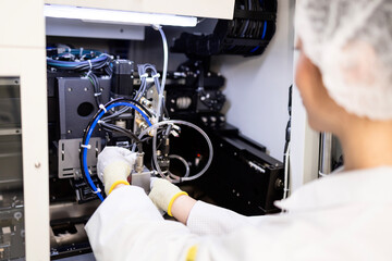 Mechatronics engineer standing by prototype machine in research and development factory.