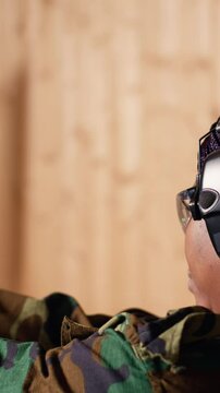 Vertical video Smiling woman in firing range doing recreational shooting activity with firearm, hitting bullseyes. Happy person in shooting gallery training with handgun, developing muscle memory