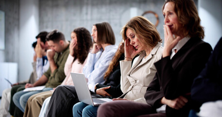 Unemployed job seekers wait in line