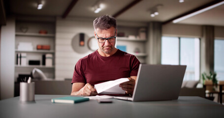 Sad Man Reading Paper Invoice