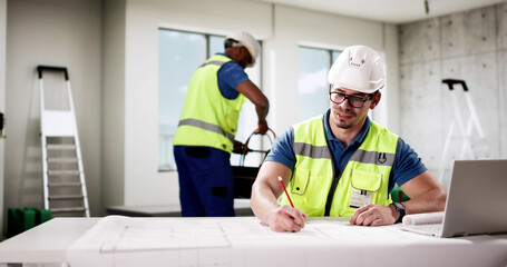 Professional foreman worker uses laptop to communicate