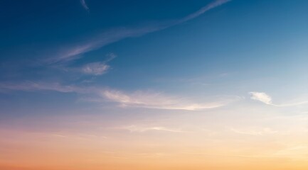 Obraz premium The Serene Sky at Dusk is adorned with Soft, Dreamy Clouds that create a tranquil atmosphere