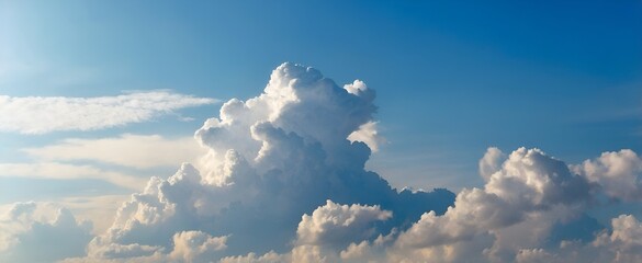 Fluffy white clouds are beautifully spread against a bright and expansive blue sky