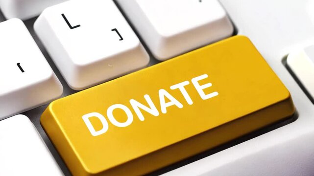 Golden donate button on keyboard with finger pushing button. A close-up image of a keyboard displaying a donation button interface with options to select donation amounts. Captures a moment of giving,