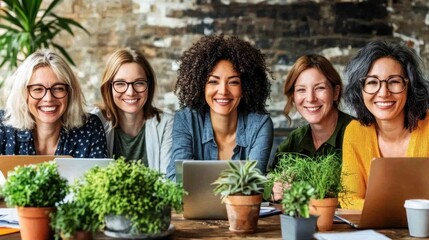 Group of Diverse Women Smiling at Laptop in Modern Office Setting