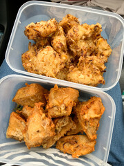 Bala-Bala or bakwan and tahu isi or gehu or stuffed tofu, Indonesian street food fritters in plastic boxes