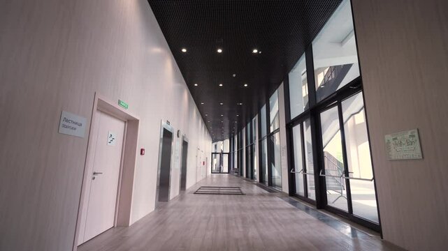 Long corridor with curved windows. Dolly camera shot