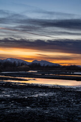 sunset in the area of the river mouth of the Bregenzer Ache into the Bodensee with reflections of...
