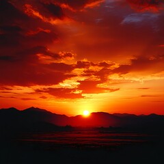 Fiery Red Sunset Over Silhouetted Mountains
