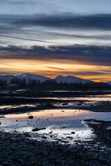 sunset in the area of the river mouth of the Bregenzer Ache into the Bodensee with reflections of...