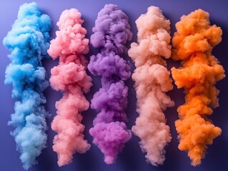 Fototapeta premium Colorful smoke clouds in various shades against a purple background.